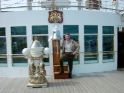 Striking a pose by the ship's bell